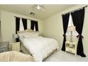 Relaxing bedroom with neutral walls, white bedding, and blackout curtains for a restful atmosphere at 4300 S Gressa St, Pahrump, NV 89061