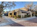 Property featuring stucco exteriors, complemented by well-maintained shrubbery and a sidewalk leading to the unit entrance at 4648 Comnor Hill Ln, Las Vegas, NV 89121