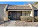 Welcoming front entrance with a decorative security gate and small garden area, creating a cozy and secure entry at 4648 Comnor Hill Ln, Las Vegas, NV 89121