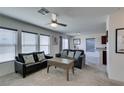 Bright living room featuring neutral walls, plush seating, and a ceiling fan at 5382 El Nevero St, Las Vegas, NV 89166