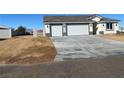 Beautiful home featuring a large driveway and minimal front yard landscaping at 6360 Montclair St, Pahrump, NV 89061