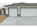 Close up view of the garage of new construction home featuring a three car garage at 6360 Montclair St, Pahrump, NV 89061