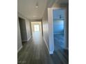 Bright hallway featuring modern lighting and a view of the open-concept living space at 6360 Montclair St, Pahrump, NV 89061