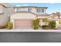 A charming two-story house features a two-car garage and landscaped front yard at 6989 Walden Park St, Las Vegas, NV 89166