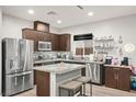 This kitchen features stainless steel appliances, granite countertops, and dark wood cabinetry at 6989 Walden Park St, Las Vegas, NV 89166