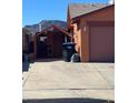 Exterior view of home and driveway with trash cans at 706 Morrocco Dr, Henderson, NV 89002