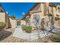 Property featuring a gated courtyard entrance with desert landscaping at 7632 Amato Ave, Las Vegas, NV 89128