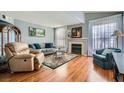 Bright living room boasting hardwood floors, a fireplace, and large windows at 7632 Amato Ave, Las Vegas, NV 89128