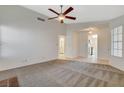 Bright living room with carpet, fireplace and a view of the entry and kitchen at 7719 Selby Ct, Las Vegas, NV 89147