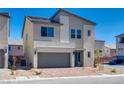 Modern two-story home featuring a two-car garage, a brick driveway, and low-maintenance landscaping at 10246 Bloom Quick Ct, Las Vegas, NV 89141