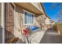 Cozy front porch seating area with stylish wicker couch and decorative side table at 1045 Chestnut Chase St, Las Vegas, NV 89138