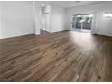 Open living area featuring wood-look flooring and sliding glass doors at 10524 India Hawthorn Ave, Las Vegas, NV 89144