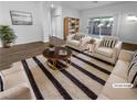 Bright, staged living room with sliding glass doors and contemporary furnishings at 10524 India Hawthorn Ave, Las Vegas, NV 89144
