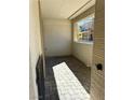 Cozy covered patio with brick flooring and a view of new home construction at 11443 Ethereal Landing Ave, Las Vegas, NV 89138