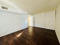 Bedroom featuring hardwood floors and a spacious closet with sliding doors at 1405 Vegas Valley Dr # 357, Las Vegas, NV 89169