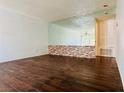Spacious living room with hardwood floors and a mirrored accent wall at 1405 Vegas Valley Dr # 357, Las Vegas, NV 89169