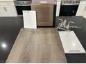New kitchen design layout features cabinet, flooring, countertop and paint samples with stainless appliances at 1513 Bat Hawk St, Las Vegas, NV 89144