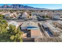 Aerial view of a residential neighborhood with desert landscaping and mountain views at 173 Betty Ln, Las Vegas, NV 89110