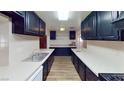 Long kitchen with white counters and black cabinets at 173 Betty Ln, Las Vegas, NV 89110