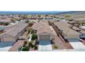 Overview of a neighborhood showcasing single-story homes with tile roofs and low-maintenance landscaping at 2351 Thornwood Castle Dr, Laughlin, NV 89029