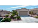 Well-maintained single-story home featuring mature landscaping, concrete driveway, and an attached garage at 2351 Thornwood Castle Dr, Laughlin, NV 89029