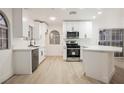 Well-lit kitchen featuring stainless appliances, white cabinetry, and a stylish breakfast bar area at 2925 Wigwam Pkwy # 923, Henderson, NV 89074