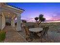 Covered patio with an outdoor dining set overlooking scenic desert landscape at 37 Avenida Fiori, Henderson, NV 89011