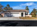 Charming single-story home with a three-car garage, well-maintained landscaping, and a welcoming front entrance at 4434 Verdiccio Ave, Las Vegas, NV 89141