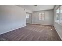 Bright living room with new carpet, fresh paint, and a window that overlooks the front yard at 457 Federal St, Henderson, NV 89015