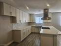 Bright, renovated kitchen featuring white cabinets, quartz countertops, and stainless steel appliances at 4905 Danbrook Ct, Las Vegas, NV 89110