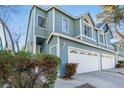 Beautiful townhouse featuring a two-car garage and manicured landscaping at 4923 Strauss Dr, Las Vegas, NV 89146