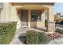 Covered porch featuring stone columns, green shrubbery, manicured rock landscaping, and a view of the street at 7222 Regent Pond St, Las Vegas, NV 89166