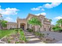 Gorgeous home featuring stone accents, lush landscaping, and a grand entryway at 807 Canyon Greens Dr, Las Vegas, NV 89144