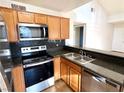 Updated kitchen with stainless steel appliances, modern backsplash and breakfast bar overlooking the living room at 9325 W Desert Inn Rd # 218, Las Vegas, NV 89117