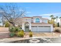 Beautiful home with a tile roof, large arched entry, and a three car garage at 1700 Monte Rio Ct, Las Vegas, NV 89128
