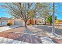 Single story home featuring low maintenance desert landscaping and an attached two-car garage at 1035 Dodger Blue Ave, Las Vegas, NV 89123