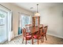 Dining room featuring wood floors, natural light, and a classic wooden dining set at 10431 Kitty Joyce Ave, Las Vegas, NV 89129