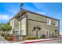 Exterior view of a multi-story condo with a well-maintained landscape and updated facade at 10431 Kitty Joyce Ave, Las Vegas, NV 89129