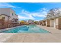 Resort-style community pool with lounge seating and covered patio area for relaxation at 10725 Wrigley Field Ave, Las Vegas, NV 89166