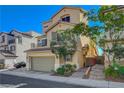 Charming stucco home featuring a two-car garage, balcony, and well-maintained landscaping at 10725 Wrigley Field Ave, Las Vegas, NV 89166