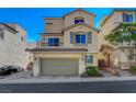 Charming two-story home featuring a two-car garage, balcony, and stylish architectural details on a sunny day at 10725 Wrigley Field Ave, Las Vegas, NV 89166