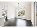 Dining room with dark floors, modern lighting, and a large window overlooking the backyard at 11 Belfair Ct, Henderson, NV 89052