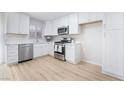 Bright kitchen features stainless steel appliances, white cabinetry, and modern countertops at 1105 Pawnee Ln, Henderson, NV 89015