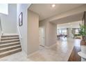 Entryway with stairs, white trim, and easy access to the dining room, kitchen, and living room at 1918 Molly Brook Dr # Lot 5, North Las Vegas, NV 89084