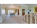 Inviting living room featuring neutral carpet, crown molding, and French doors leading to the outdoor area at 2246 Almart Cir, Henderson, NV 89014