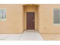 Close-up of the secure front entrance featuring a decorative security door and desert landscaping at 2404 Garganey Ave, North Las Vegas, NV 89084