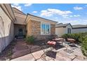 Inviting front porch with stone pavers and comfortable seating, perfect for relaxing outdoors at 2467 Moonlight Valley Ave, Henderson, NV 89044