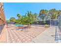 Paver-covered community space with picnic tables and recreational area next to pool at 2825 E Hacienda Ave, Las Vegas, NV 89120