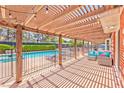 Relaxing patio area with a pergola, string lights, and comfortable seating, overlooking the pool at 2825 E Hacienda Ave, Las Vegas, NV 89120