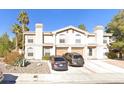 Inviting two-story townhome featuring attached garages and a tidy landscaped front yard at 2834 Crystal Lantern Dr, Henderson, NV 89074